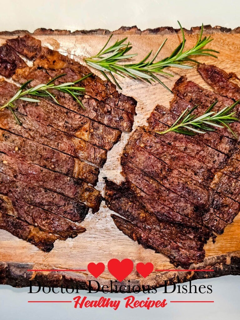 A delicious serving of thin-cut grilled ribeye steaks paired with crispy sweet potato fries and grilled corn on the cob, beautifully presented on a white plate with a rustic wooden background.