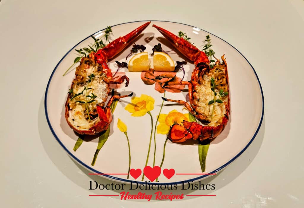 Grilled whole lobster cut in half and served on a decorative floral plate.