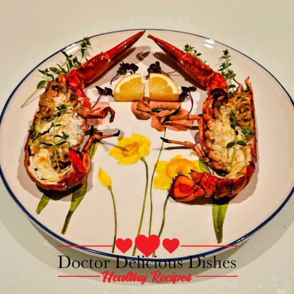 Grilled whole lobster cut in half and served on a decorative floral plate.