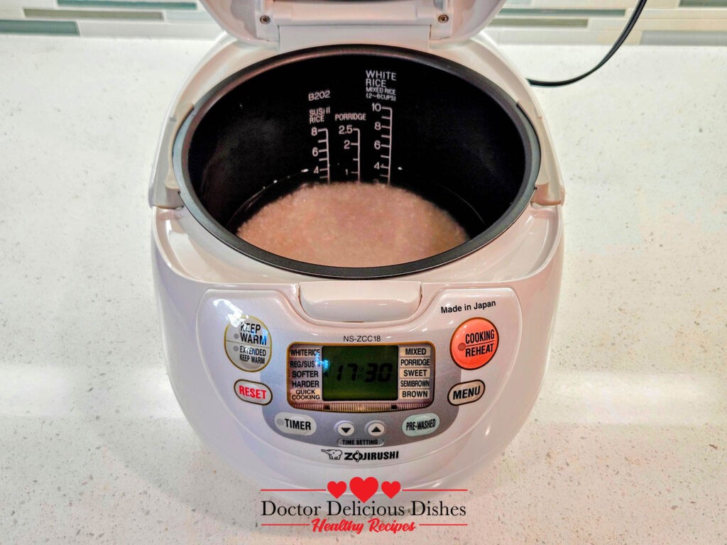 Rice cooking inside the Zojirushi rice cooker for the Chinese Beef and Broccoli Recipe.