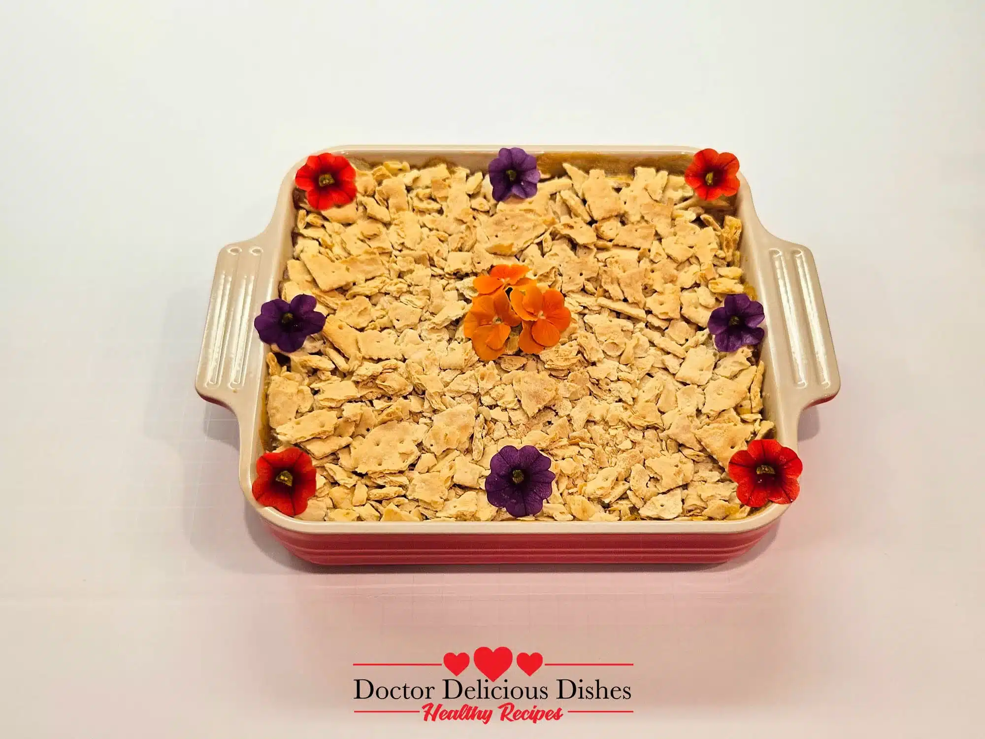 Garnished cracker corn casserole with edible flowers, ready to serve.
