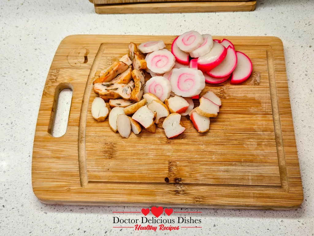 Fish cakes sliced into rounds and bite-sized pieces, ready to be added to soba noodle soup.