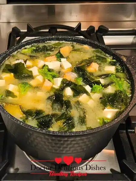 The sixth image presents a pot filled with the completed Savory Salmon Tofu Miso Soup with Broccoli, ready to serve.