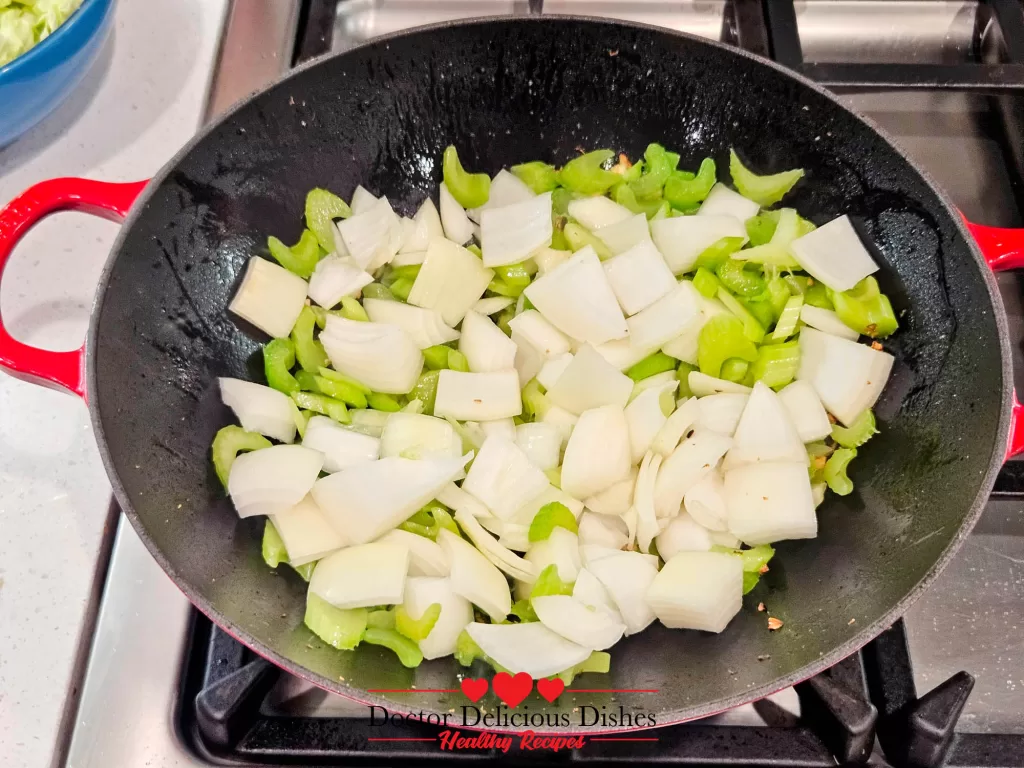 Large chunks of yellow onions added to the wok, cooking alongside the celery to develop their mild, caramelized flavor for the chow mein.