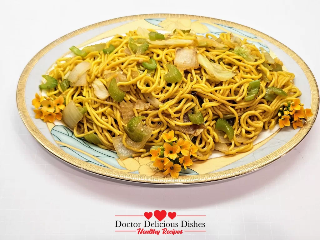 Final plated dish of Copycat Panda Express Chow Mein Noodles, served on a decorative plate, garnished with small orange flowers for presentation.