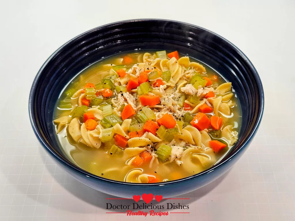 A steaming bowl of Homemade Chicken Noodle Soup with Egg Noodles, showcasing hearty vegetables and tender noodles.