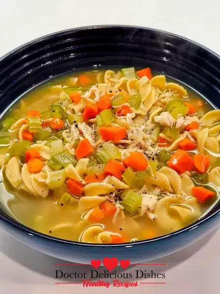 A steaming bowl of Homemade Chicken Noodle Soup with Egg Noodles, showcasing hearty vegetables and tender noodles.