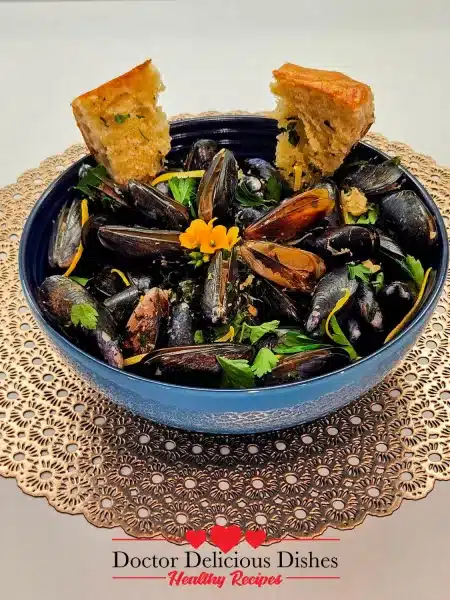 A close-up of Garlic Butter White Wine Mussels served with toasted bread, perfect for soaking up the flavorful broth.