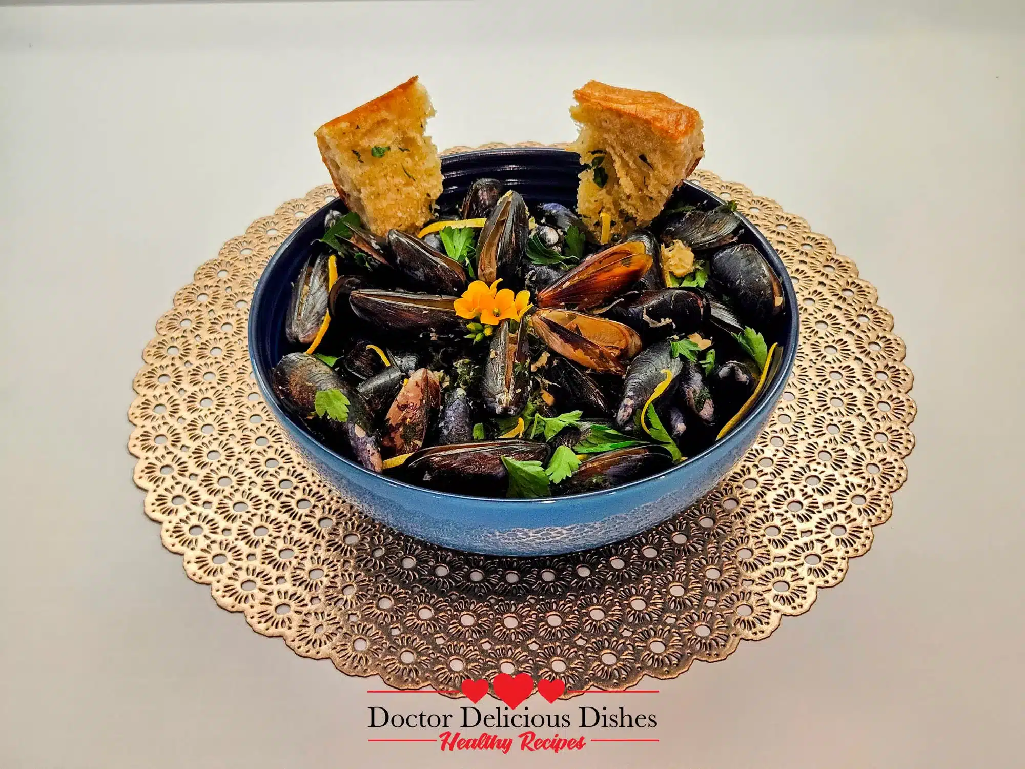 A close-up of Garlic Butter White Wine Mussels served with toasted bread, perfect for soaking up the flavorful broth.