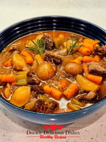 A delicious bowl of Hearty Instant Pot Beef Stew, garnished with fresh rosemary and ready to be enjoyed.