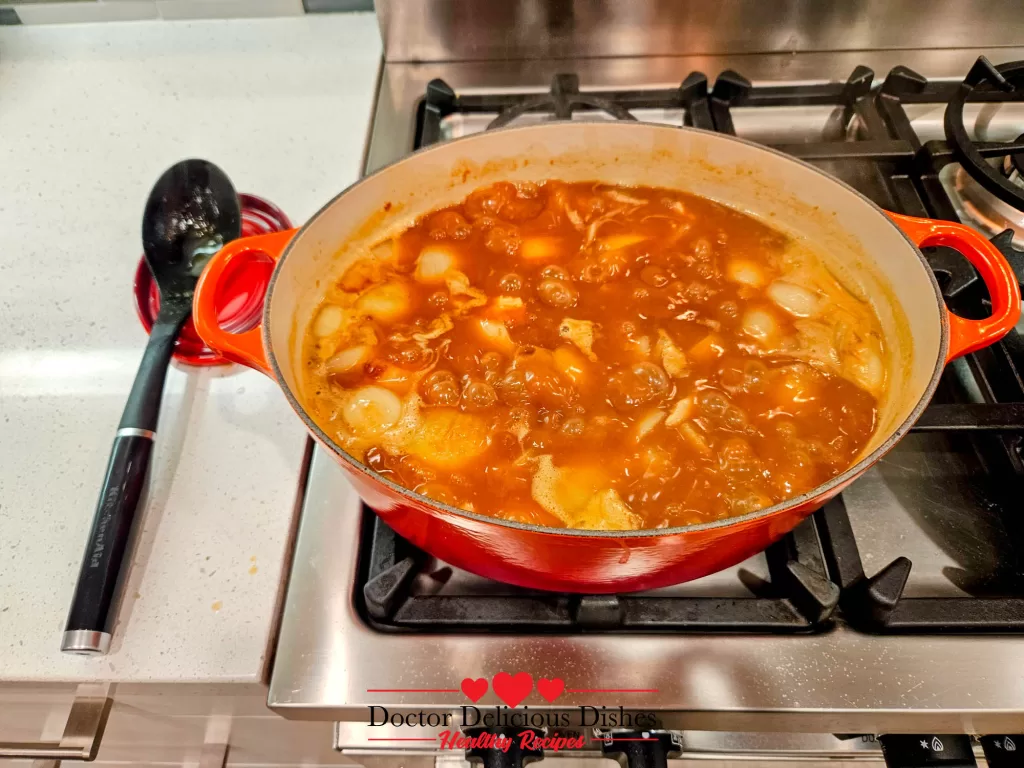 A simmering curry sauce with chicken, onions, carrots, and potatoes in the Dutch oven, the heart of a delicious Japanese Chicken Curry Recipe.