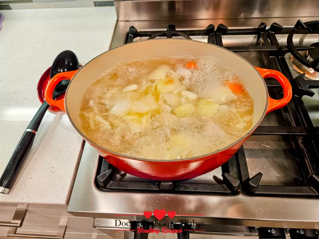 A simmering mix of chicken, onions, carrots, and potatoes in the Dutch oven, the heart of a delicious Japanese Chicken Curry Recipe.