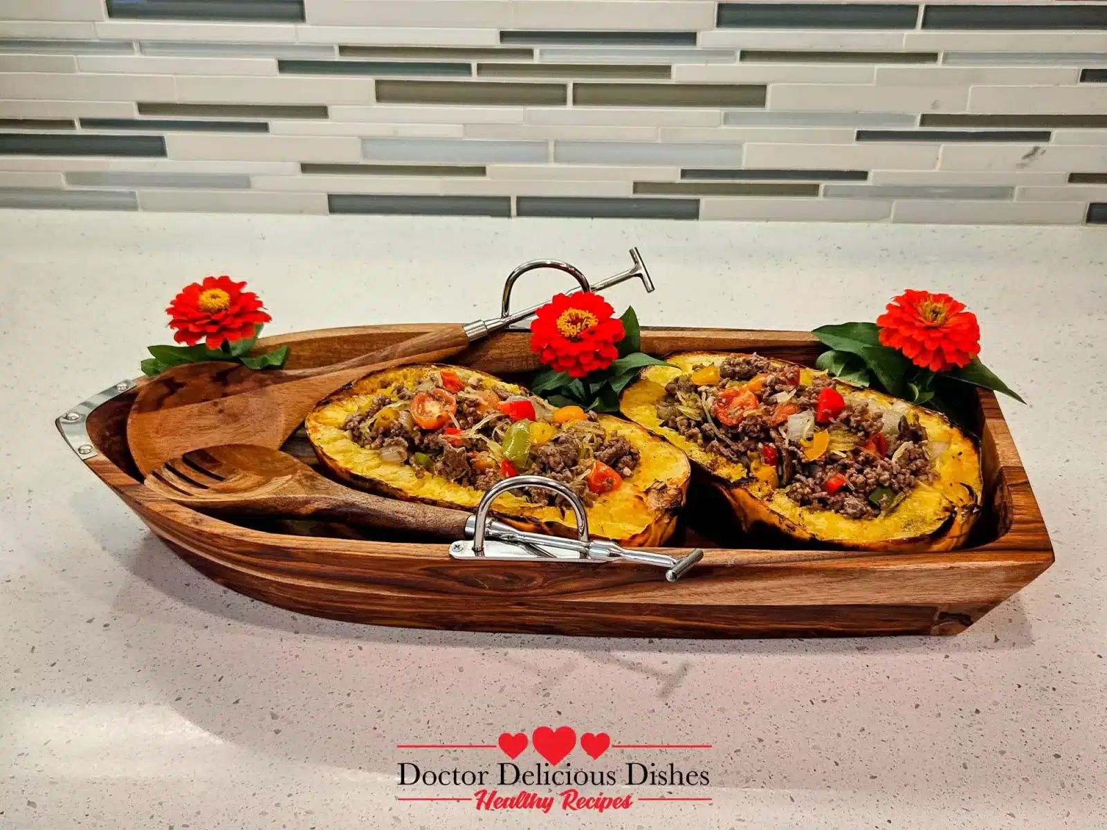 Beautifully plated ground beef recipe with spaghetti squash served inside the grilled squash shells in a wooden serving tray with flowers for decoration.