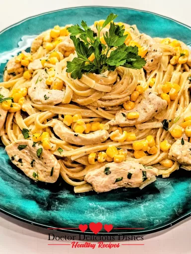 A completed plate of Chicken Alfredo pasta with corn, garnished with fresh parsley and served on a turquoise dish for a Chicken Alfredo Recipe with Jar Sauce.