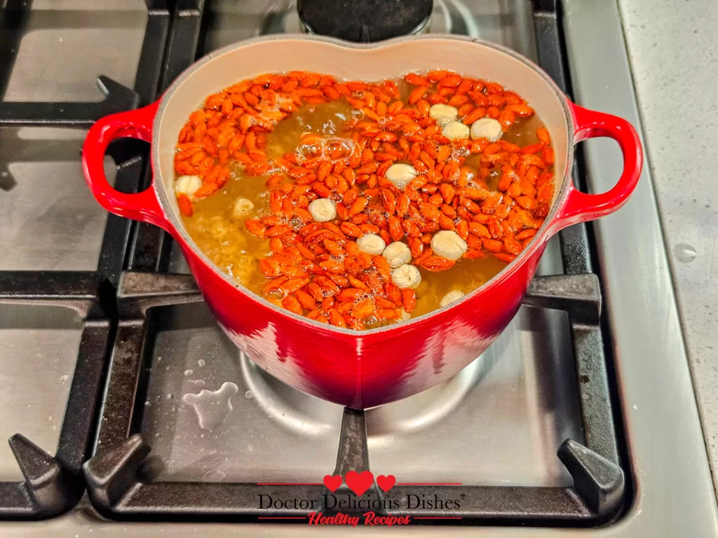 Lotus seeds added to the Le Creuset pot with goji berries, slowly infusing flavor into the Easy Tong Sui Recipe.