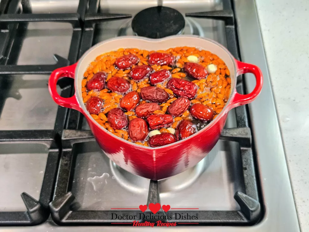 Red dates/Jujube are added to the simmering goji berries and lotus seeds in the Le Creuset pot, deepening the sweetness of the Easy Tong Sui Recipe.