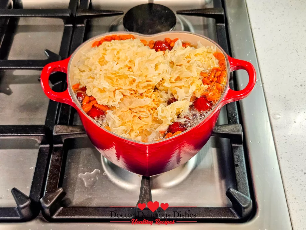 Dried snow fungus added to the Le Creuset pot, expanding and absorbing the rich flavors of Easy Tong Sui Recipe.