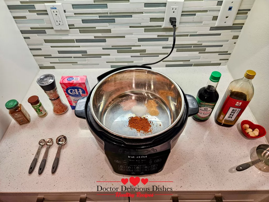 Instant Pot with dry seasonings added for marinating the pork belly.