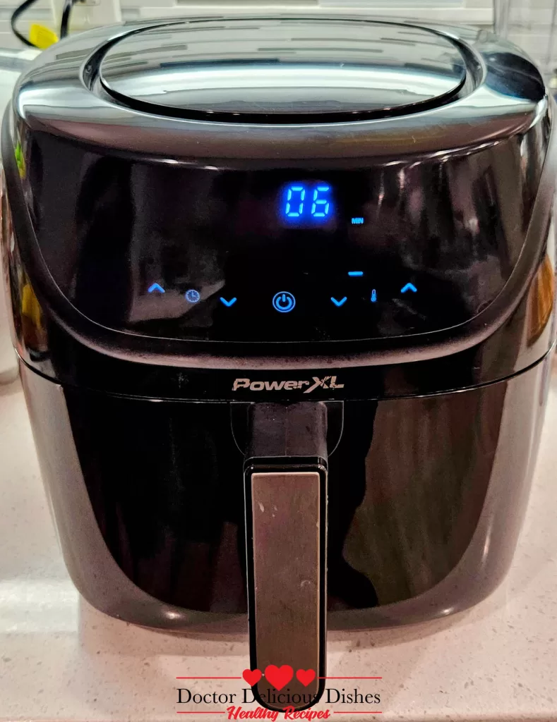 PowerXL air fryer displaying six minutes left on the timer while finishing off Crispy Air Fryer Chicken Tenders.