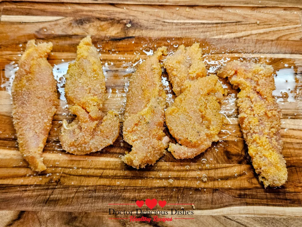 Breaded Crispy Air Fryer Chicken Tenders lightly sprayed with avocado oil to achieve a crispy golden crust.