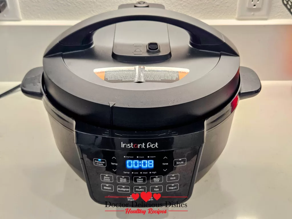 Instant Pot lid secured and timer set to cook chicken thighs for 8 minutes