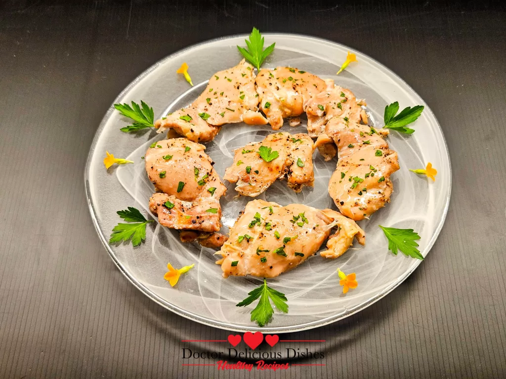 Plated Instant Pot Chicken Thighs garnished with parsley and flowers for serving