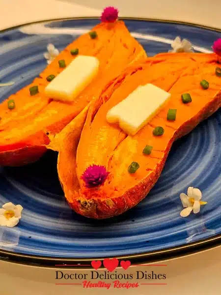 Close-up of sweet potato with melted butter and edible flowers