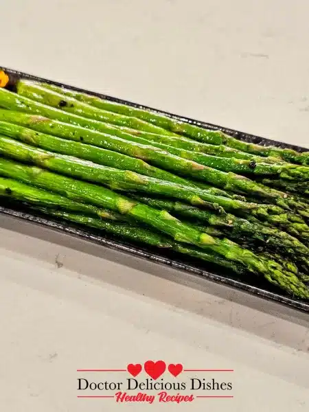Close-up of tender roasted Air Fryer Asparagus plated and garnished.