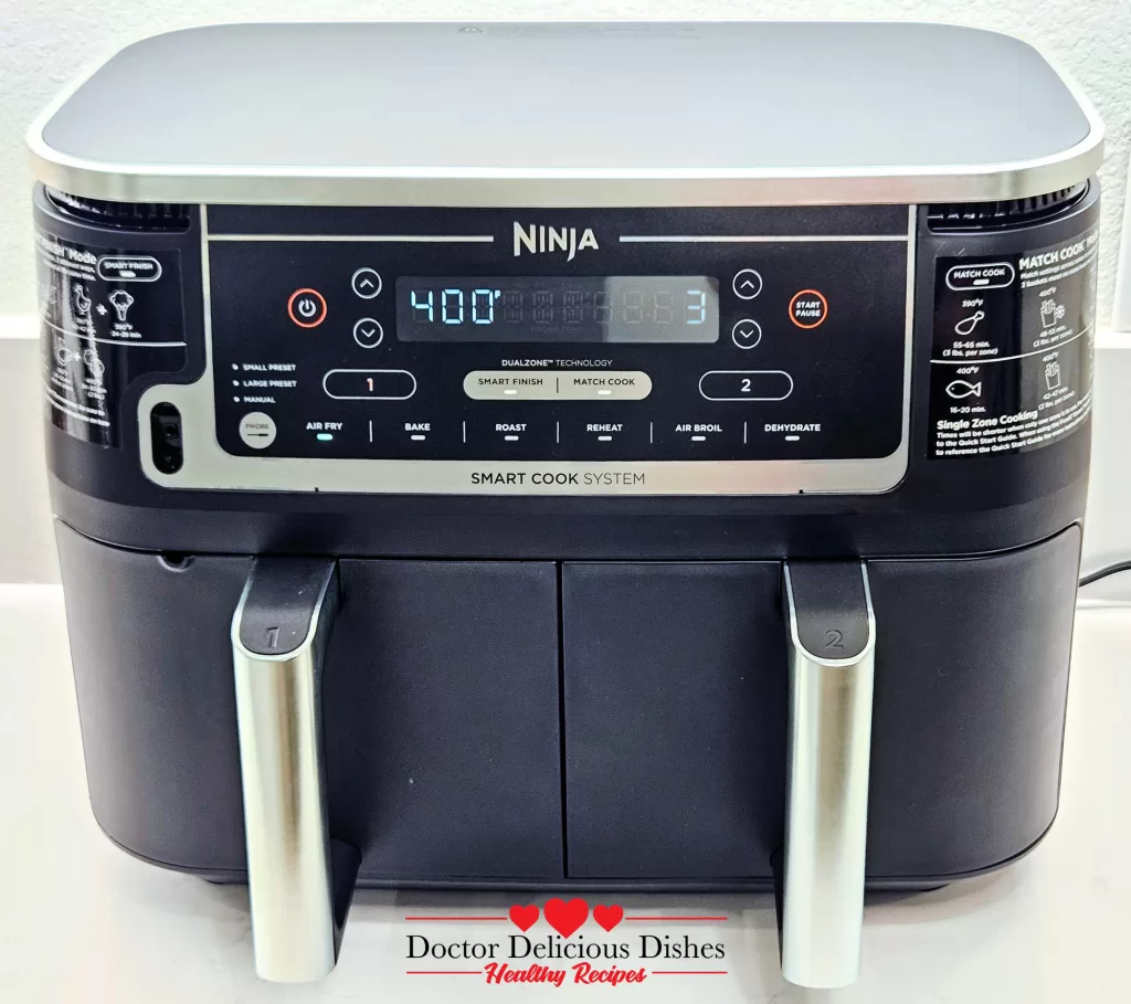 Front view of a Ninja Smart Cook System dual-zone air fryer, with the display set to 400 degrees Fahrenheit, ready for cooking.