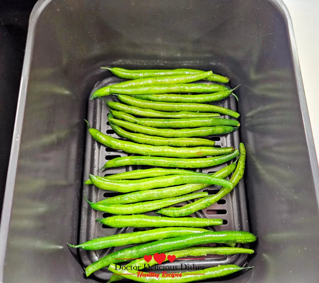 Air Fryer Green Beans arranged in a single basket, ready to be cooked