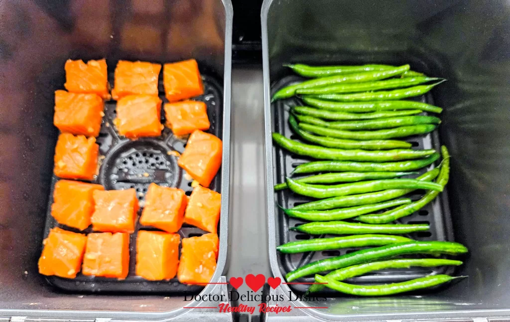 Air Fryer Green Beans paired with salmon bites in a dual-basket air fryer showing perfect side dish pairing