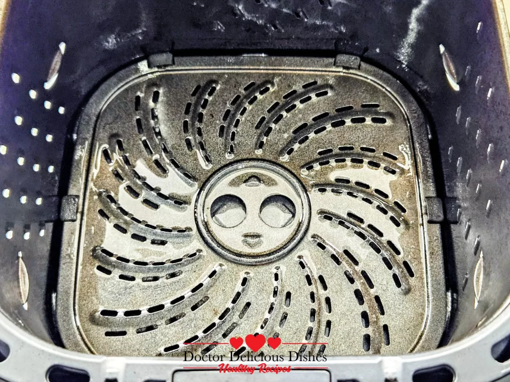 Clean air fryer basket ready for Air Fryer Salmon fillets.