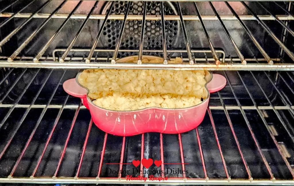 Apple blueberry crumble recipe baking in oven until golden brown.