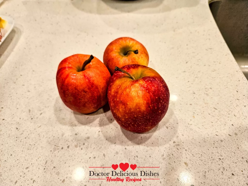 Fresh red apples on the counter for apple blueberry crumble recipe.