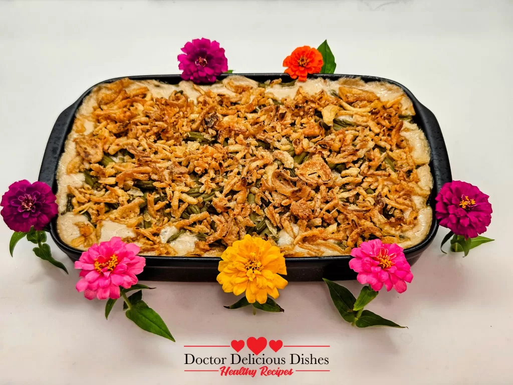 Green bean casserole recipe baked in a dish and decorated with colorful flowers for the holidays.