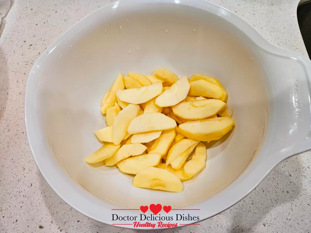 Freshly sliced apples in a bowl for apple blueberry crumble recipe.