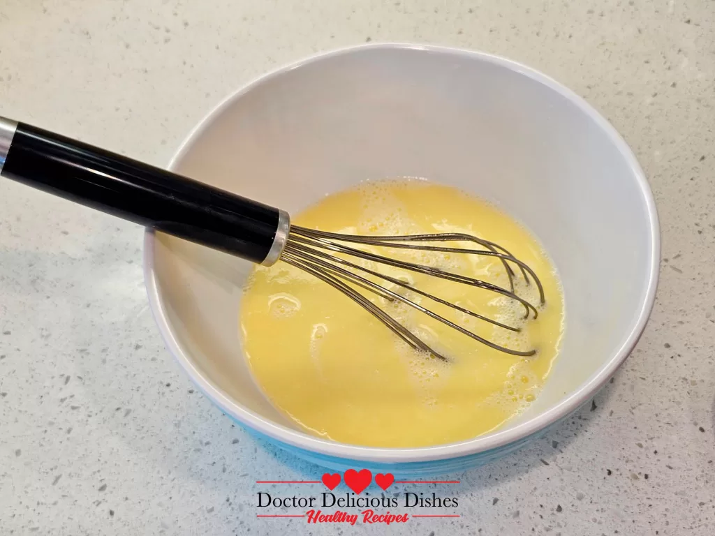 Mixing eggs, milk, and melted butter for Southern cornbread recipe