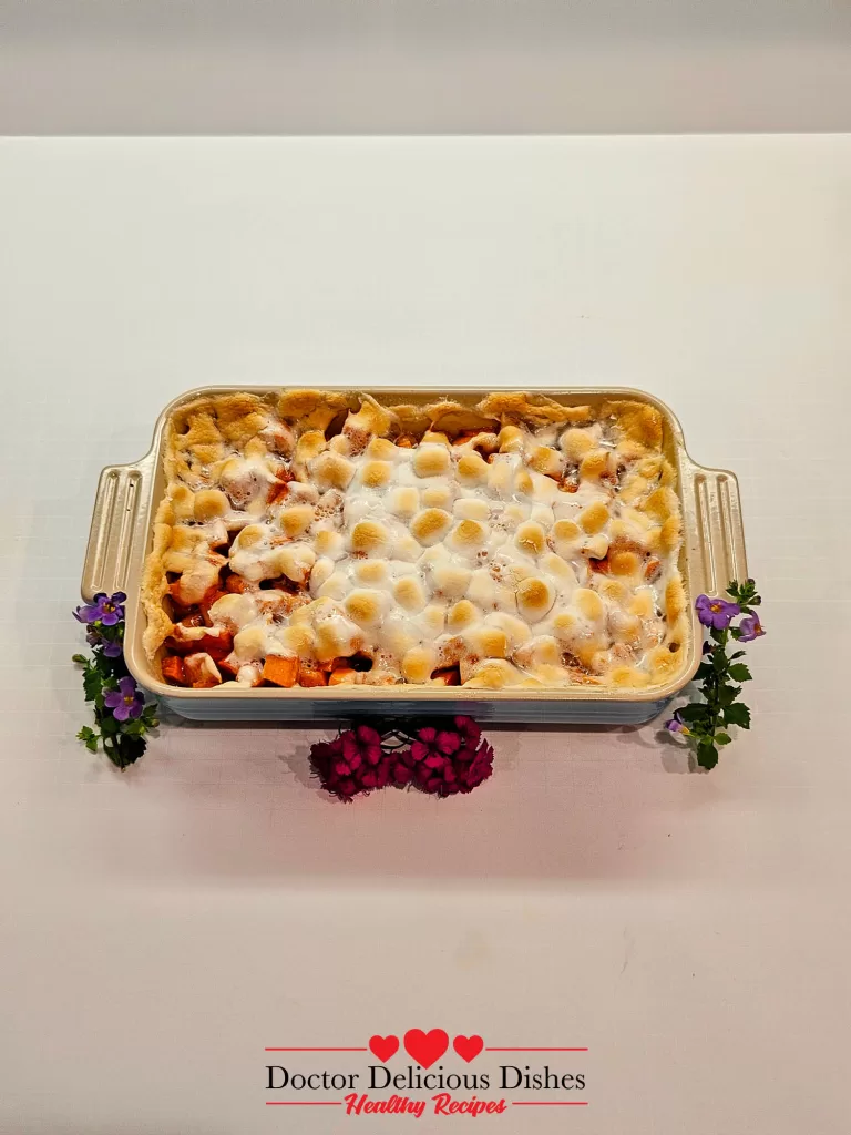 Golden baked sweet potato casserole recipe with puffed marshmallows.