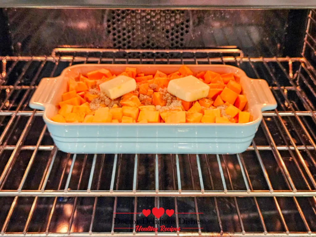 Sweet potatoes with butter and sugar baking in the oven for sweet potato casserole recipe.