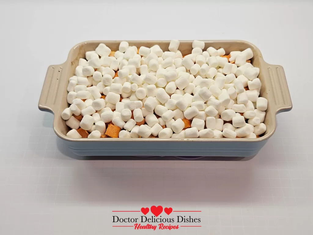 Sweet potato casserole recipe topped with mini marshmallows before baking.