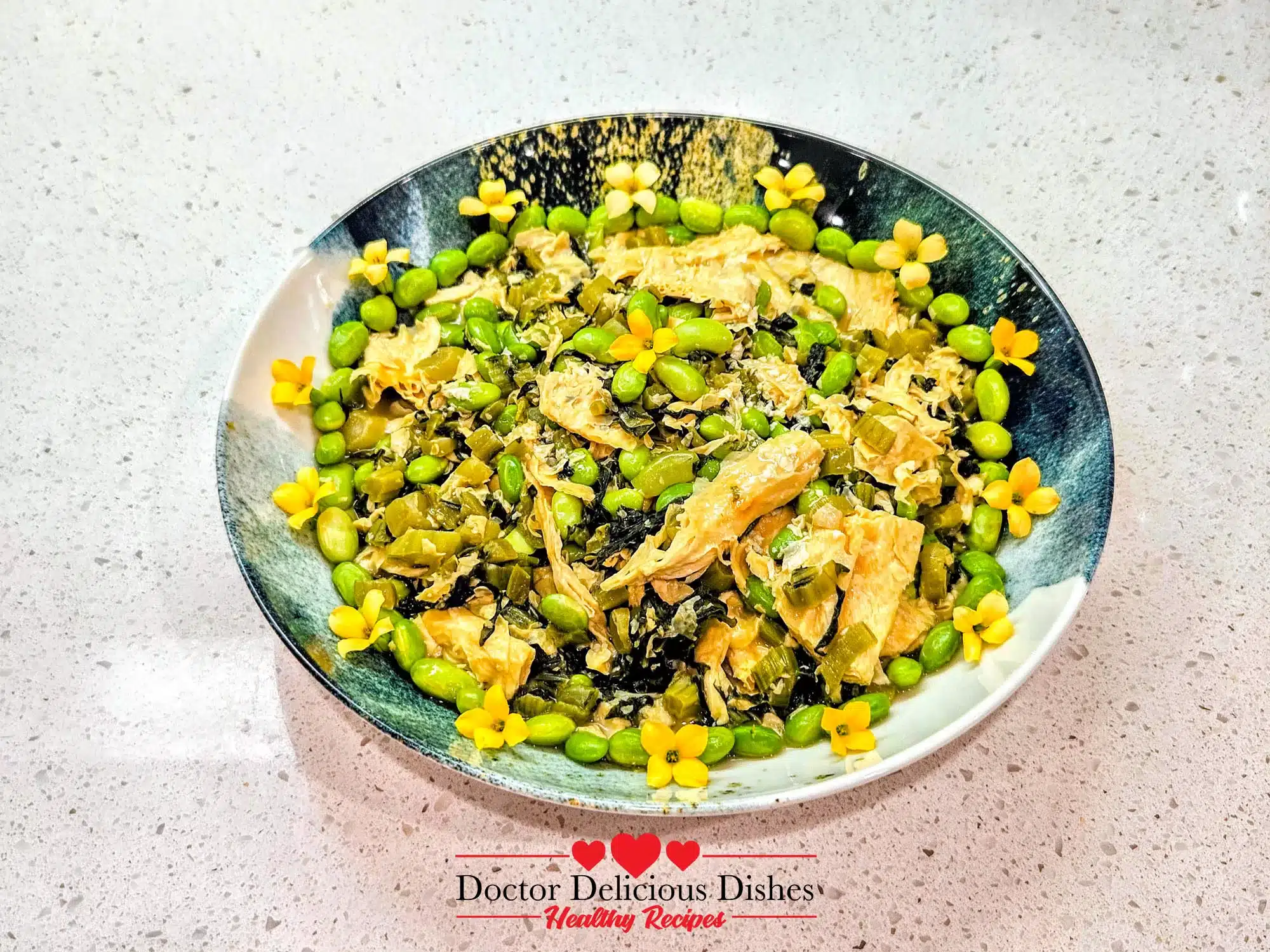 Finished tofu skin recipe plated with edamame and edible flowers for garnish.