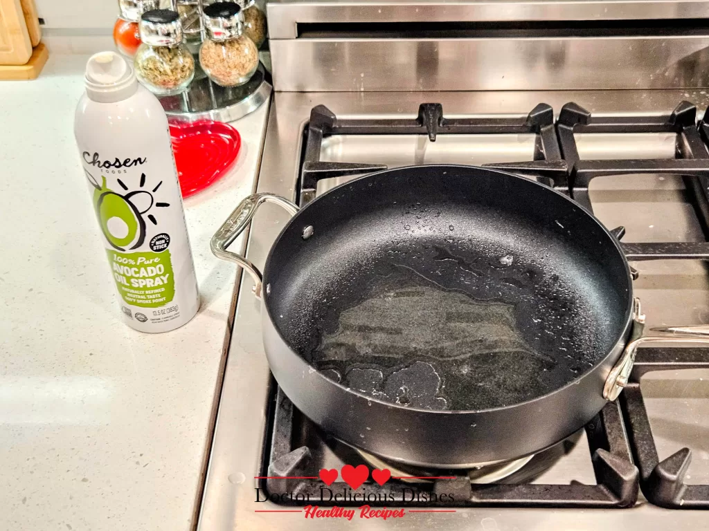 Skillet sprayed with avocado oil heating on stove for tofu skin recipe.