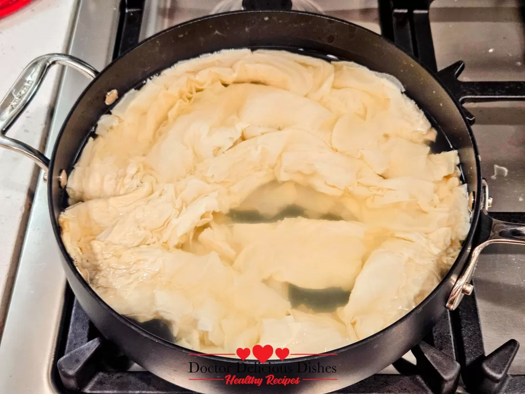 Dried tofu skin soaking in water until soft and pliable for tofu skin recipe.