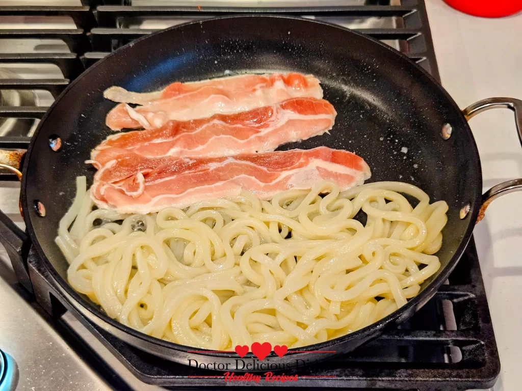Thin slices of pork added to the skillet with udon noodles to make Japanese Yaki Udon Recipe.