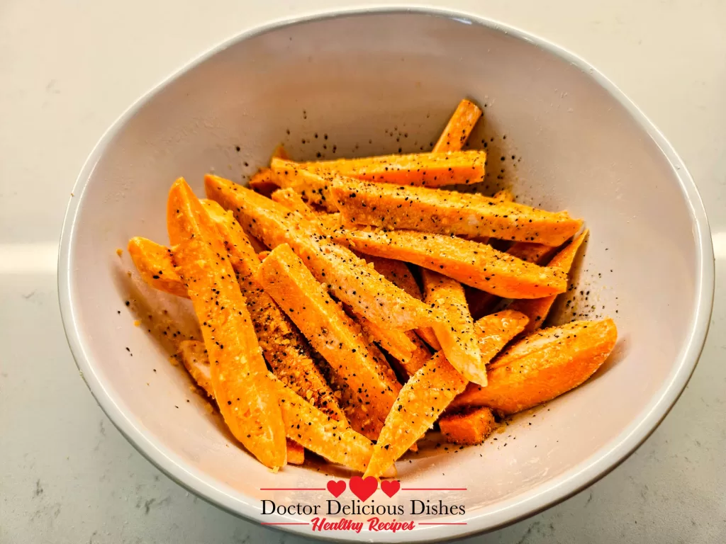 Sweet potato fries tossed with Kinder’s seasoning in a bowl for air fryer cooking – Doctor Delicious Dishes