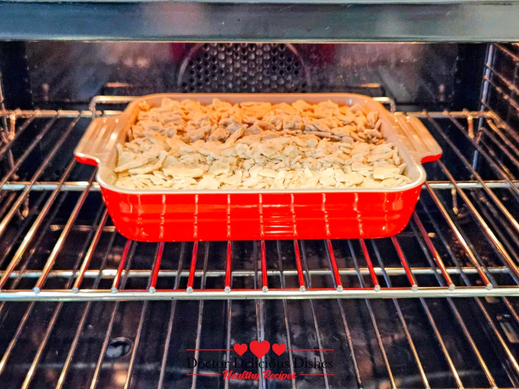 Easy Corn Casserole Recipe baking in the oven with buttery cracker topping.