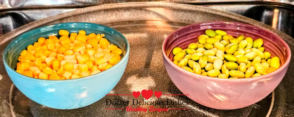 Bowls of edamame and corn being microwaved as colorful toppings for Chicken Soboro Don by Doctor Delicious Dishes.