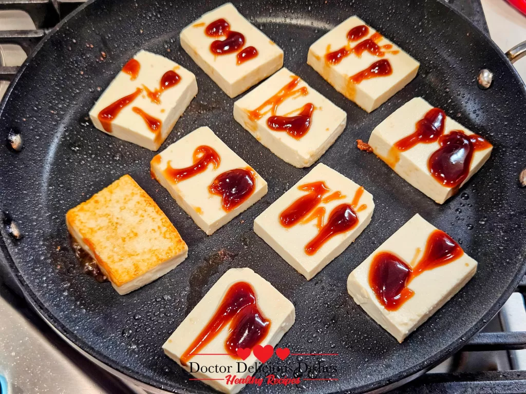 Tofu caramelizing in oyster sauce for a glossy finish in the Tofu with Oyster Sauce recipe.