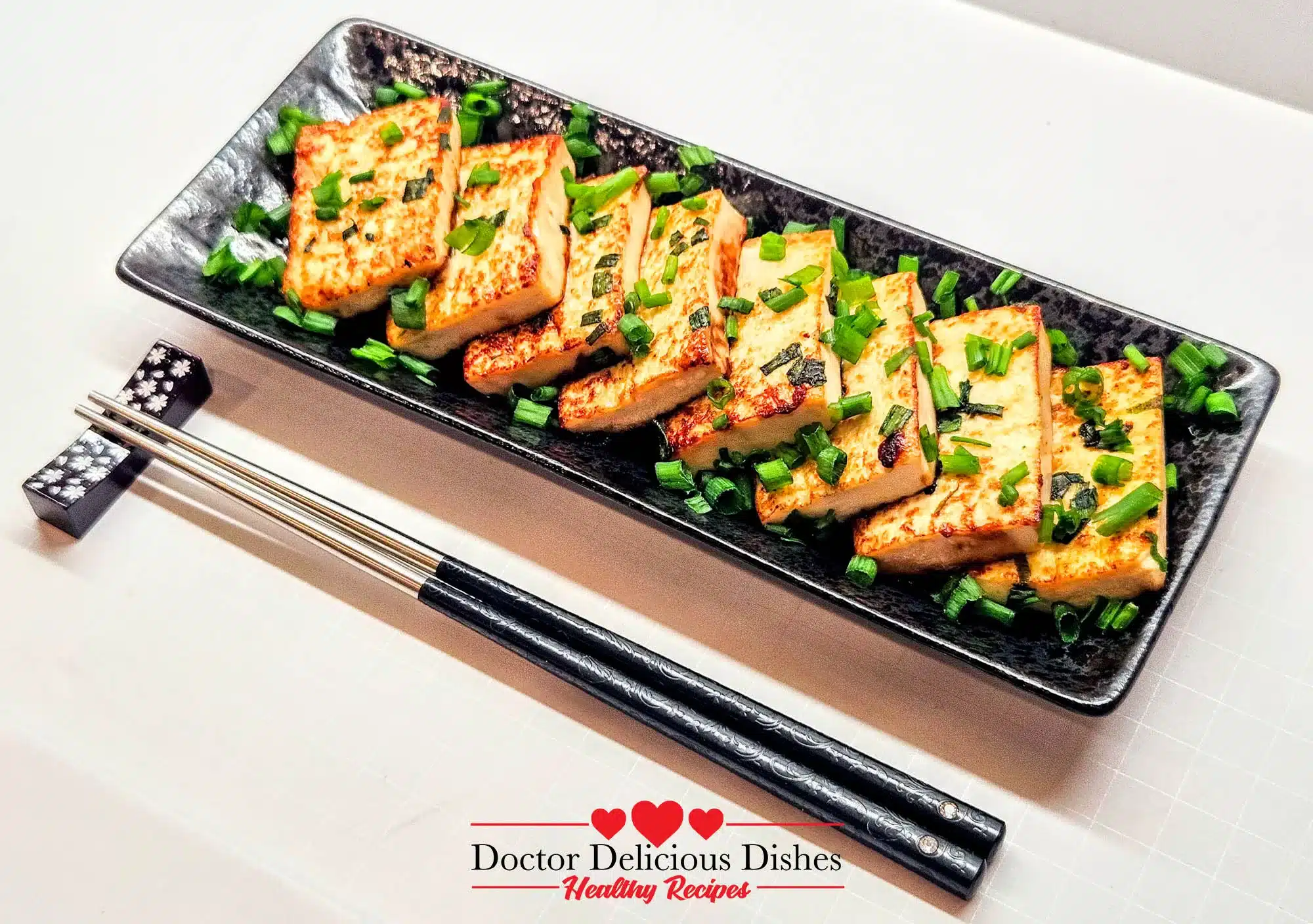Close-up of Tofu with Oyster Sauce showing crispy edges and green onion garnish.