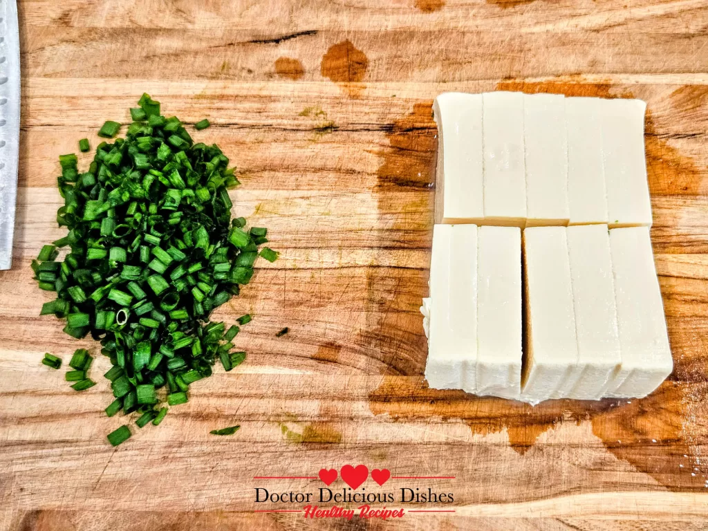Soft tofu sliced evenly into rectangles for Tofu with Oyster Sauce recipe.